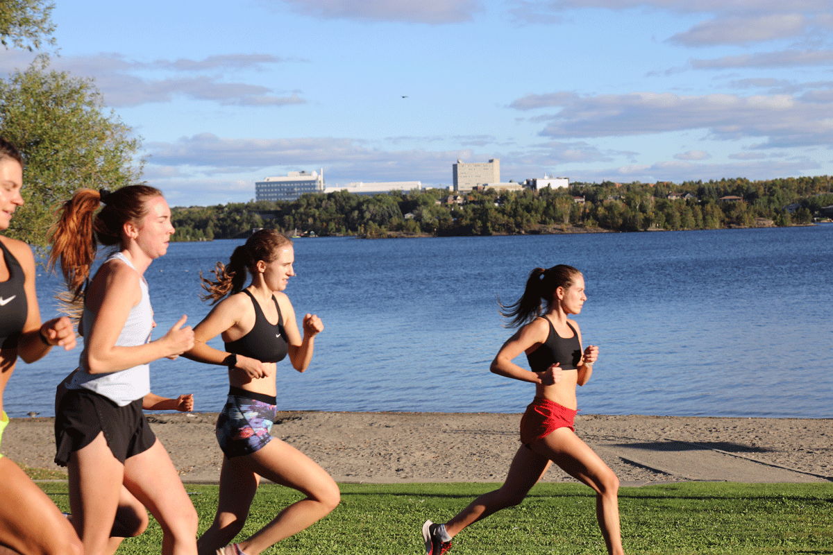 Women's team training along the lakeside trails at Laurentian University