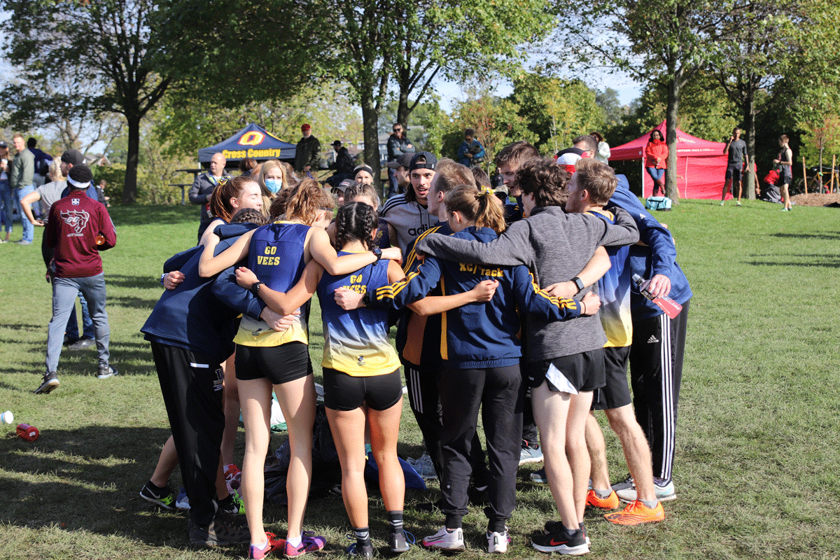 Laurentian University Voyageurs team huddle before a cross country race