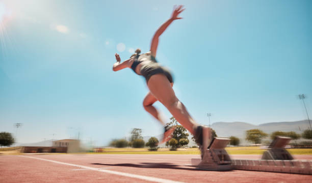 female sprinter coming out of the sprint blocks fast on the track